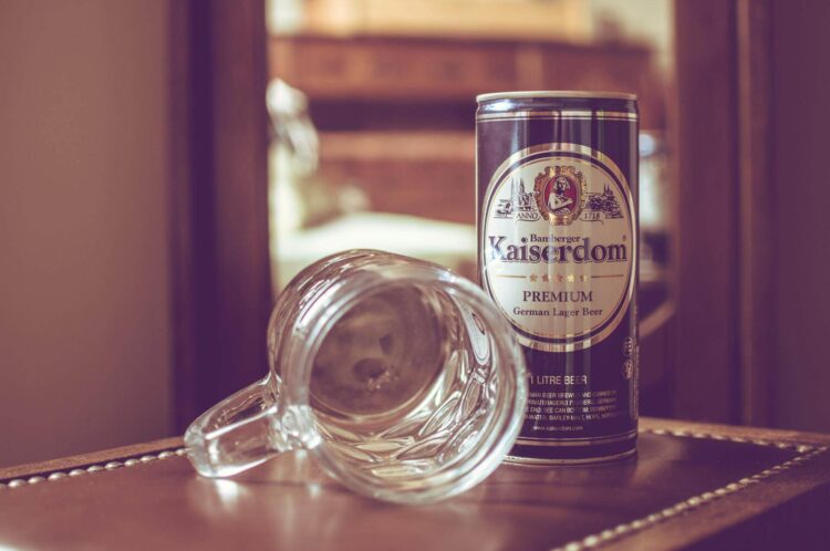 A tin of germs lager and an empty beer mug