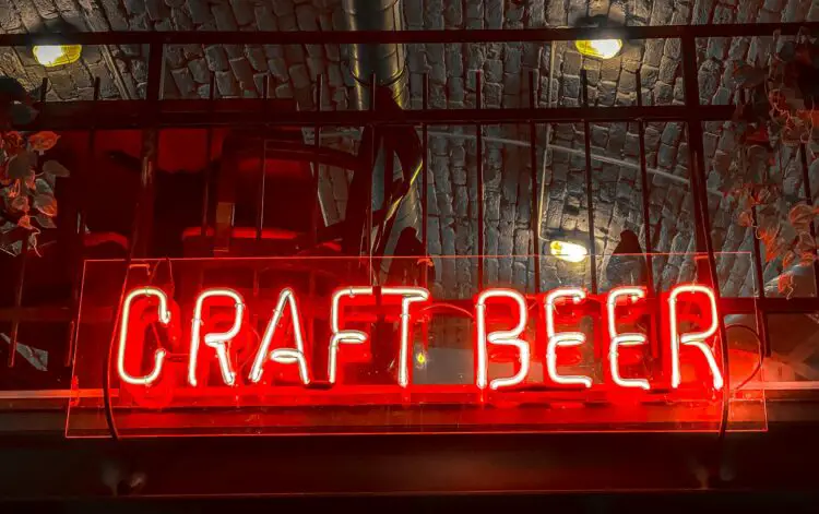 A neon craft bear sign in a bar