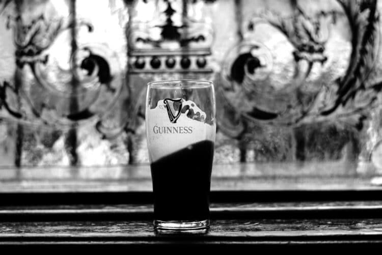 A partially consumed pint of Guiness