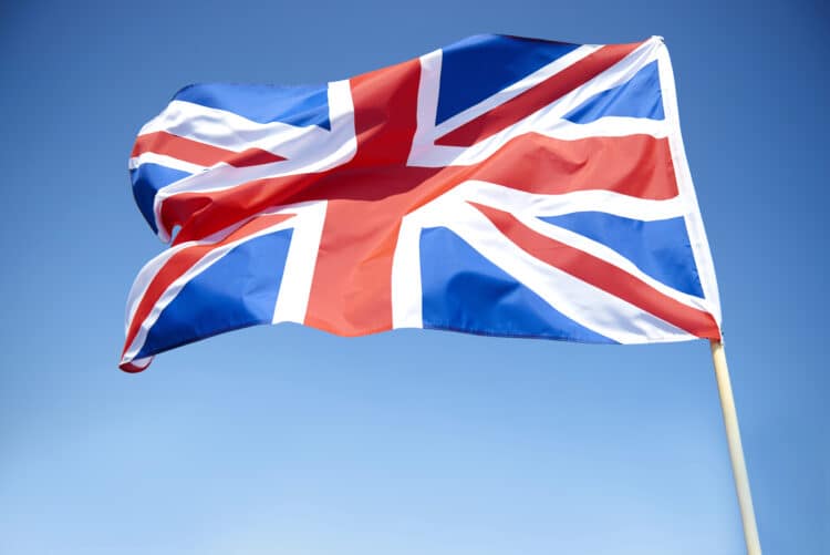 The U.K. Union Jack flag flying against a blue sky